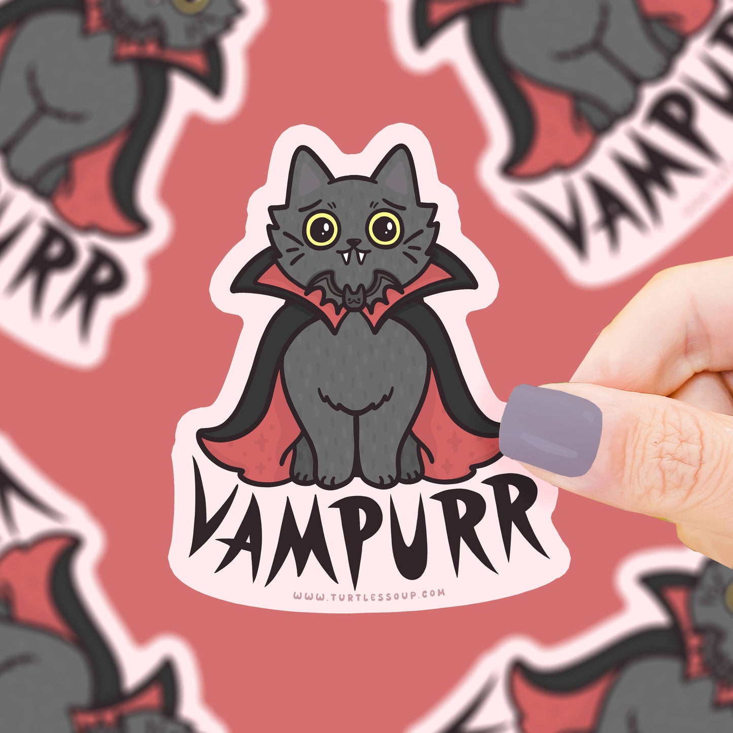 Pegatina con forma de gato adorable con capa de vampiro y colmillitos