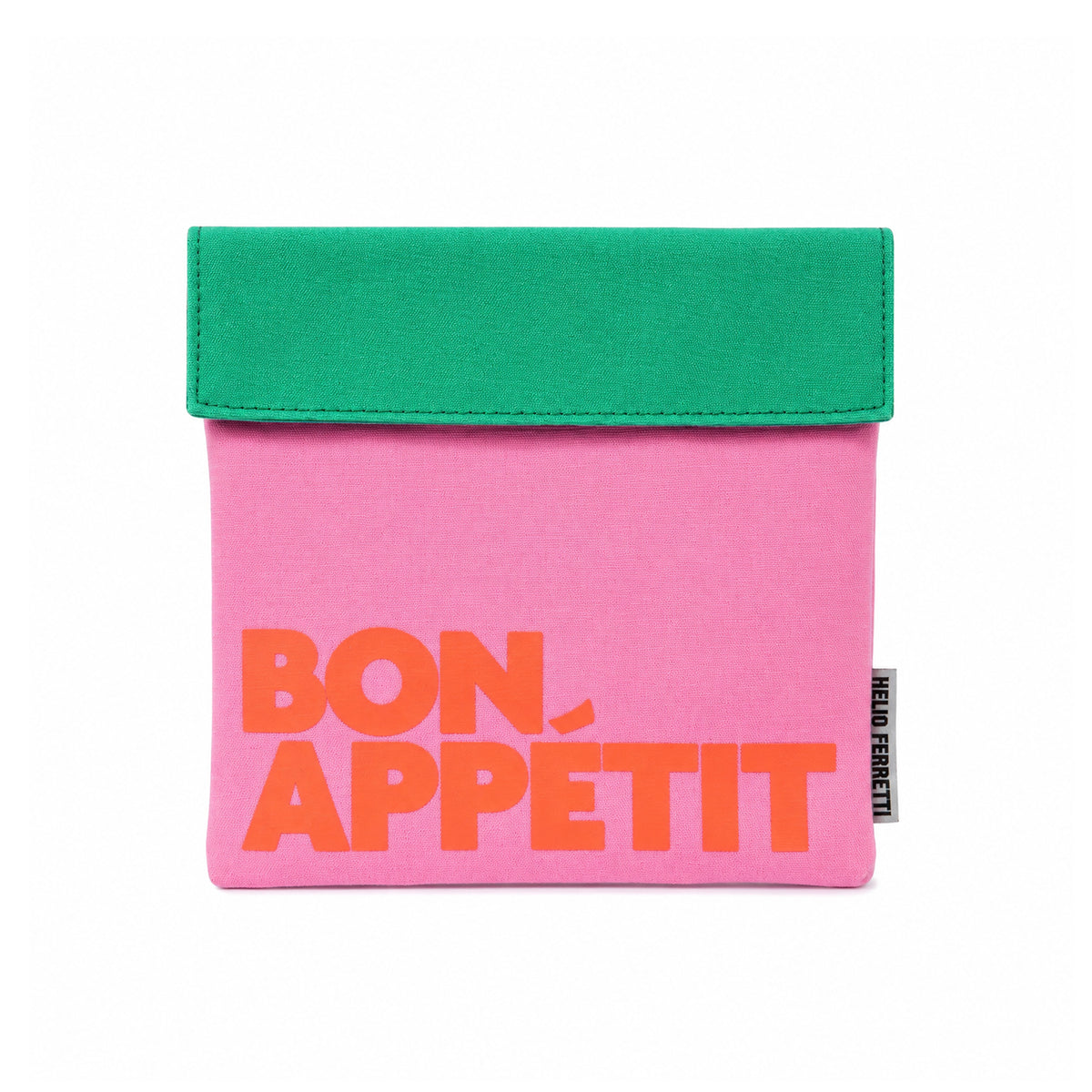Bolsa de almuerzo Bon Appétit de Helio Ferretti en rosa, con solapa verde y letras naranjas, vista frontal.