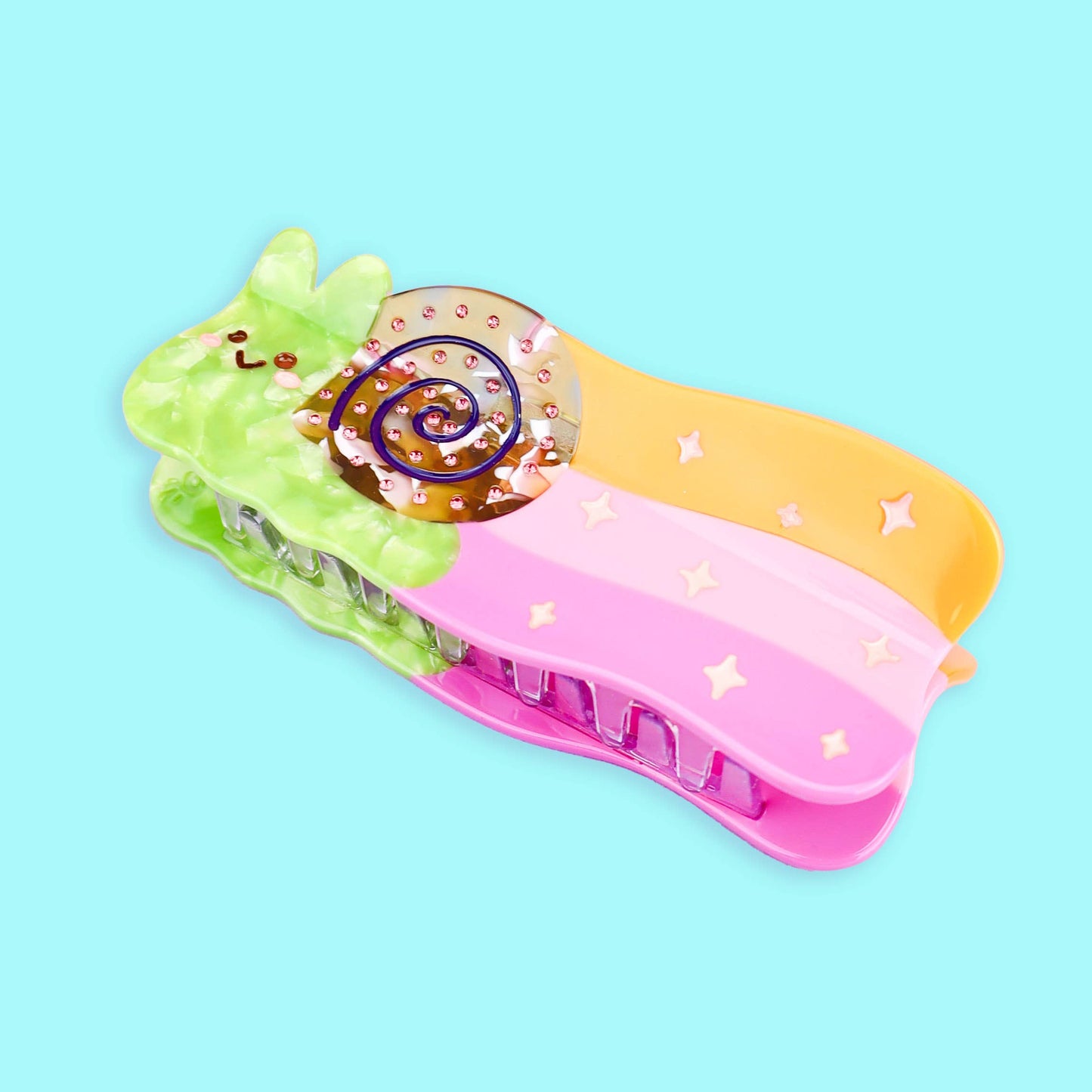 Pinza para el pelo de colores con forma de caracol dejando rastro de arcoiris