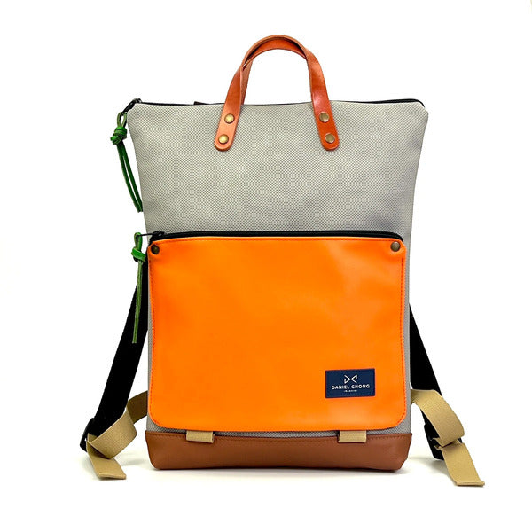 Mochila sostenible de Daniel Chong con bolsillo delantero con cremallera en piel naranja
