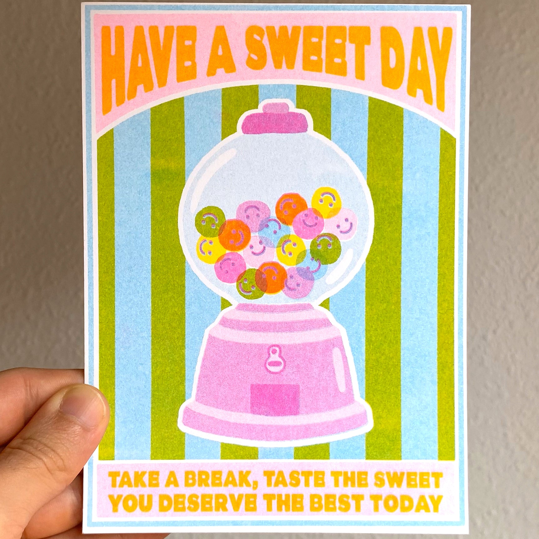Mini print con una máquina de caramelos de colores y el mensaje Have a sweet day. Take a break, taste the sweet. You deserve the best today.