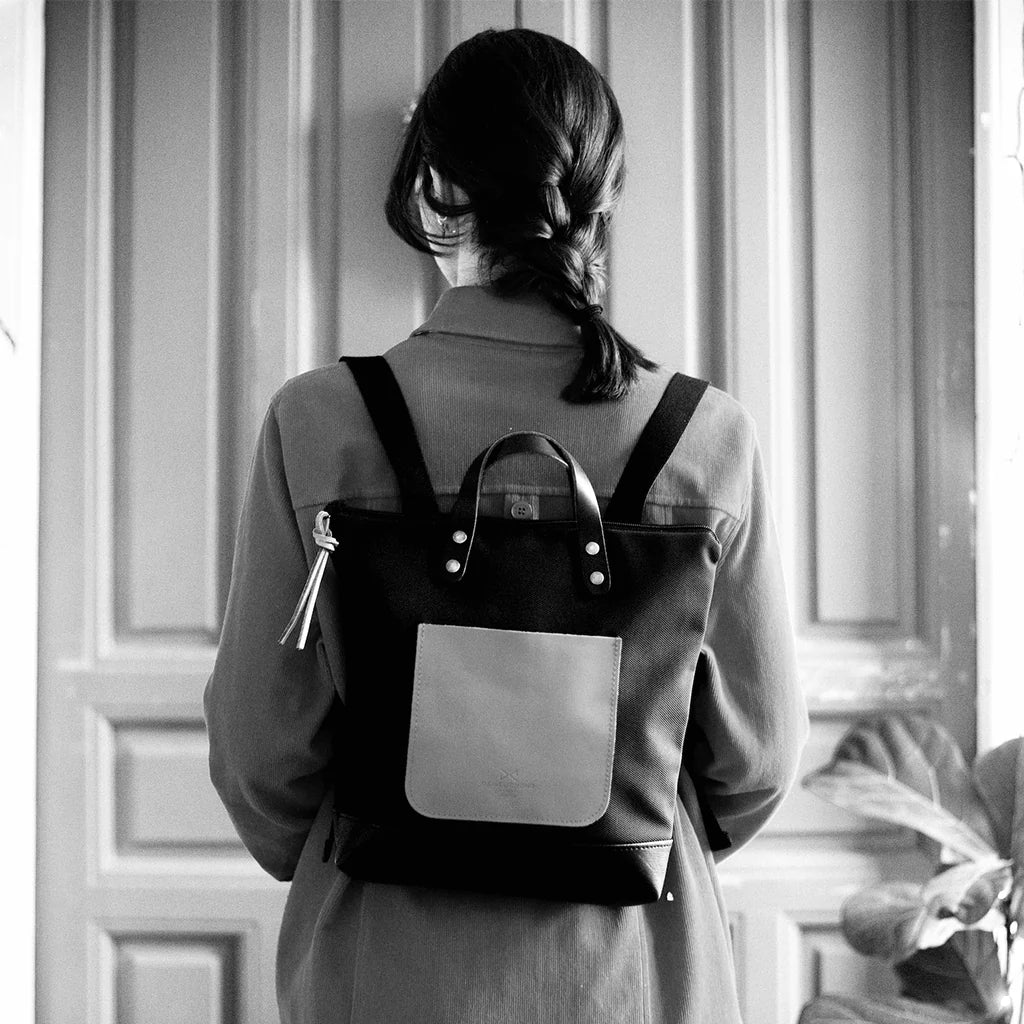 Mucjer de espaldas con chaquete y la mochila mini cuadrada de Daniel Chong