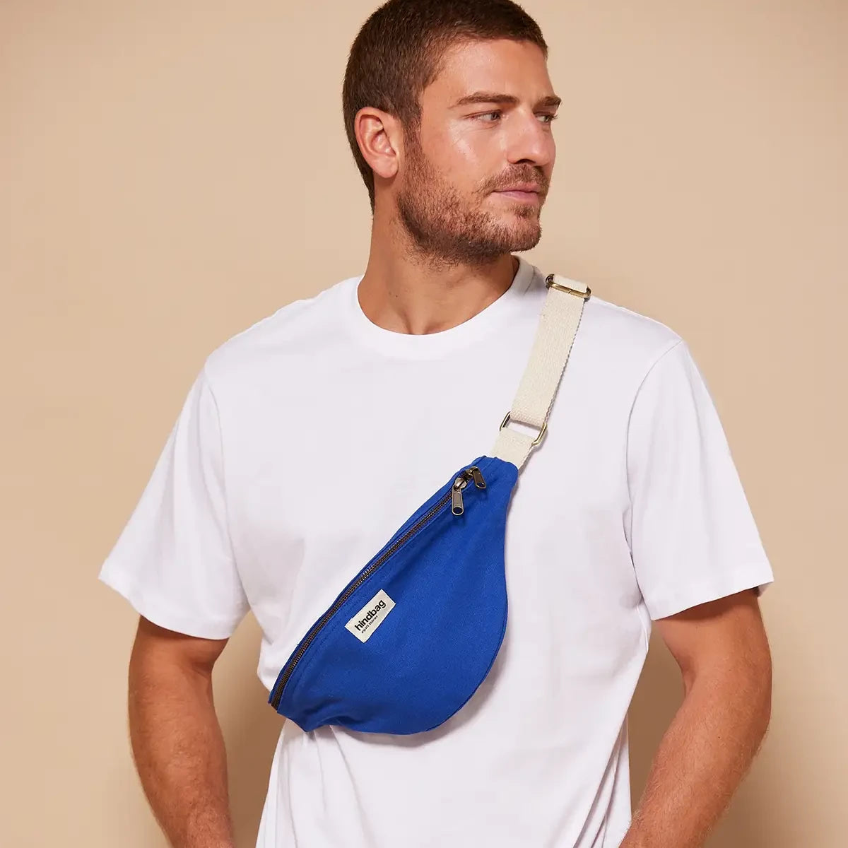 Hombre con la riñonera de algodón orgánico en color azul eléctrico de la marca francesa Hindbag