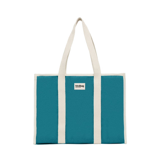 Bolso grande y cuadrado estilo tote bag de color azul turquesa con asas beige para llevar al hombro de la marca Hindbag