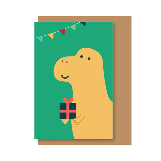 Tarjeta de Navidad con sobre craft y un dinosaurio con un regalo y banderines de colores sobre fondo verde