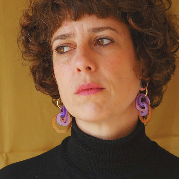 Mujer con pendientes de metacrilato con cuatro aros de colores