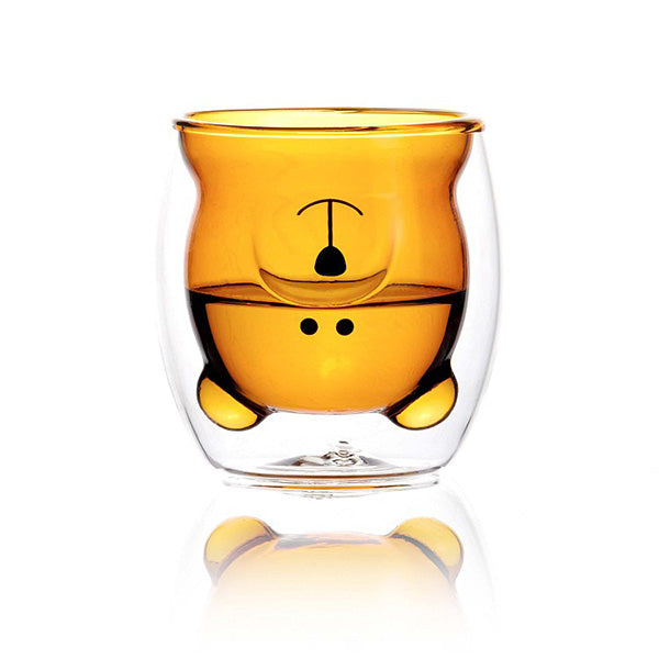 Vaso de vídrio de doble pared con la silueta de un oso color ámbar en el interior medio lleno de agua