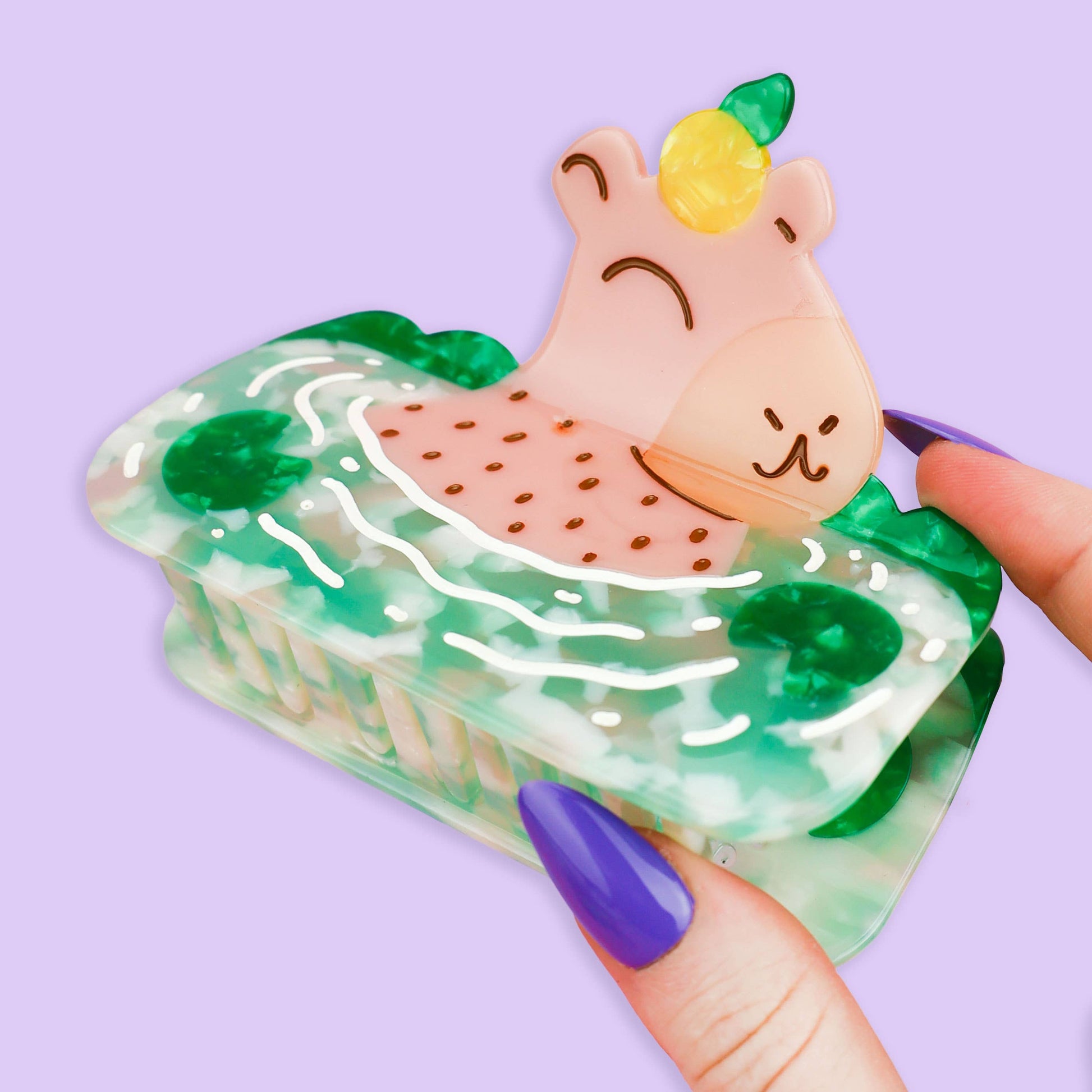 Pinza de pelo grande con forma de Capibara tomando un baño