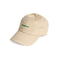 gorra de Helio Ferretti con el texto Bonjour en verde y la gorra en color camel