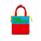 Bolsa isotérmica azul de Helio Ferretti con mensaje «Bon Appétit» en verde, asas rojas, dos bolsillos frontales rojos y cremallera amarilla.
