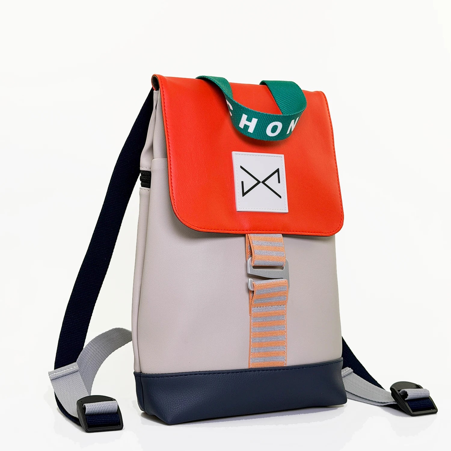 mochila the hook mini de daniel chong en color gris, la solapa en color naranja, la base azul y el asa en color verde