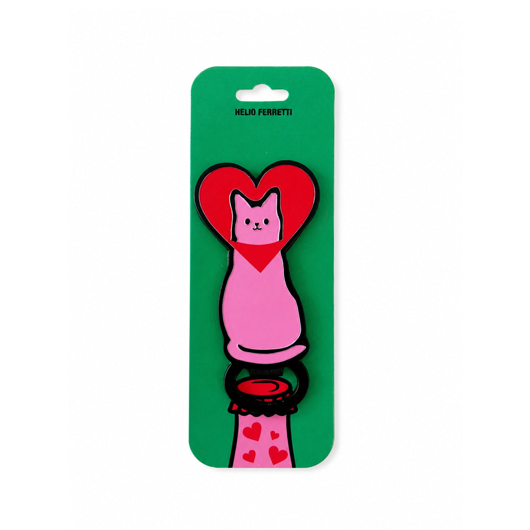 Abridor con forma de gato rosa con la cabeza metida en un corazón rojo de Helio Ferretti