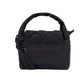 Parte trasera del mini bolso Ani de Lefrik en negro con bolsillo exterior de cremallera y bandolera ajustable