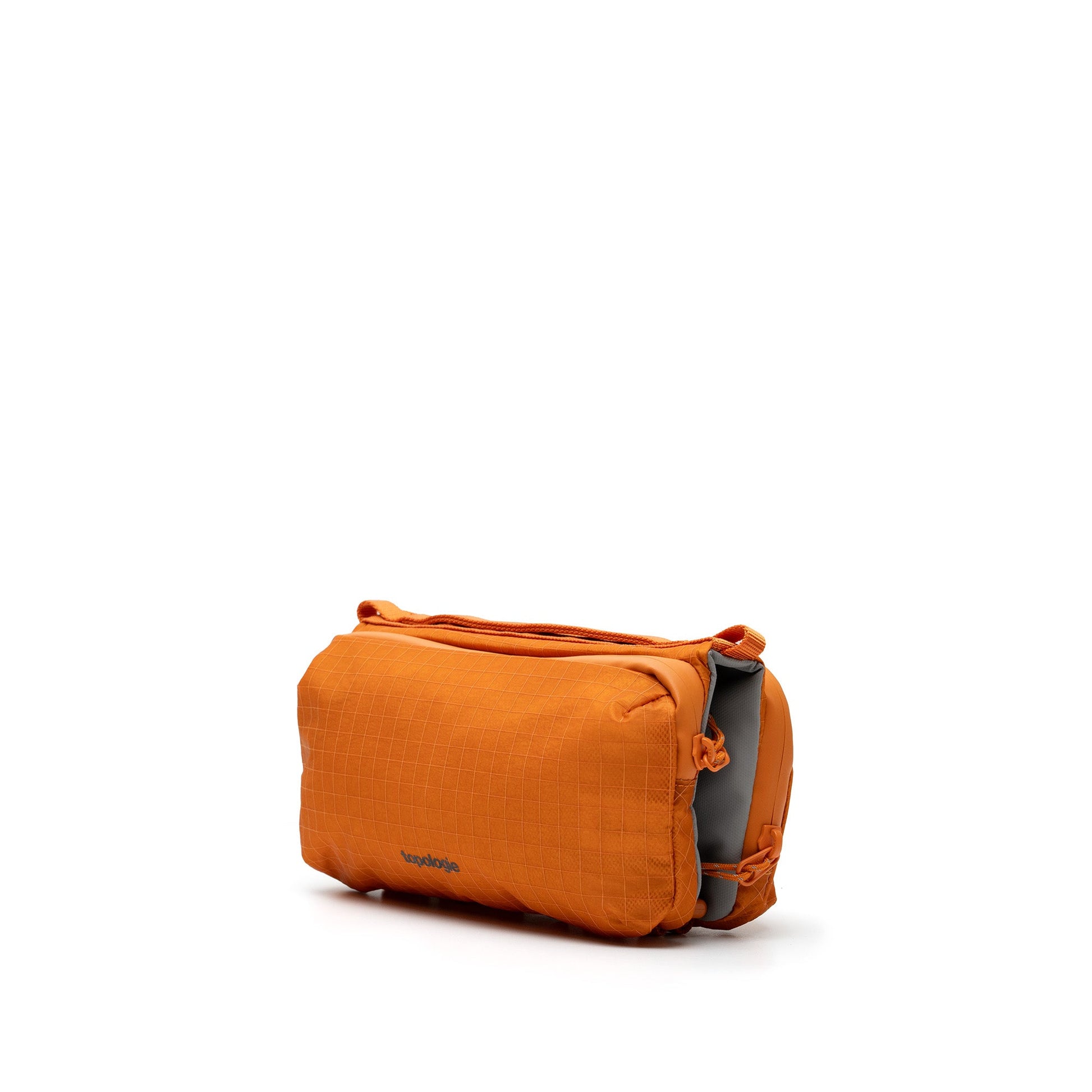 Parte delantera de bolso Bottle Sacoche naranja con el logo de topologie en la parte baja del bolso, sobre fondo blanco. 