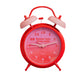 reloj despertador retro de color rosa y rojo con el texto "Better late than ugly"