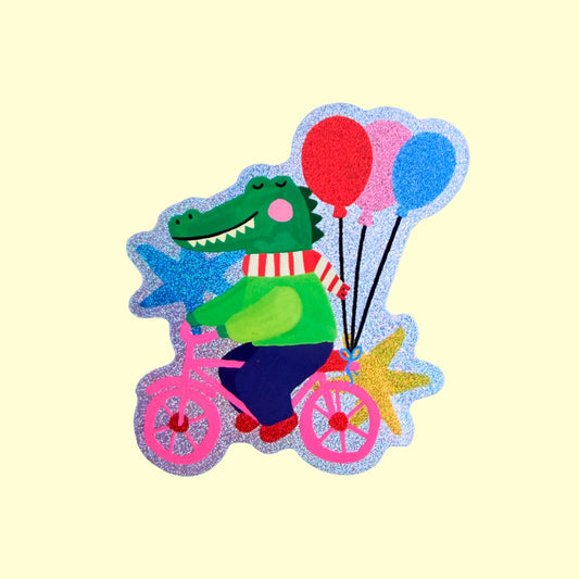 pegatina de cocodrilo subido en bici con globos en fondo amarillo