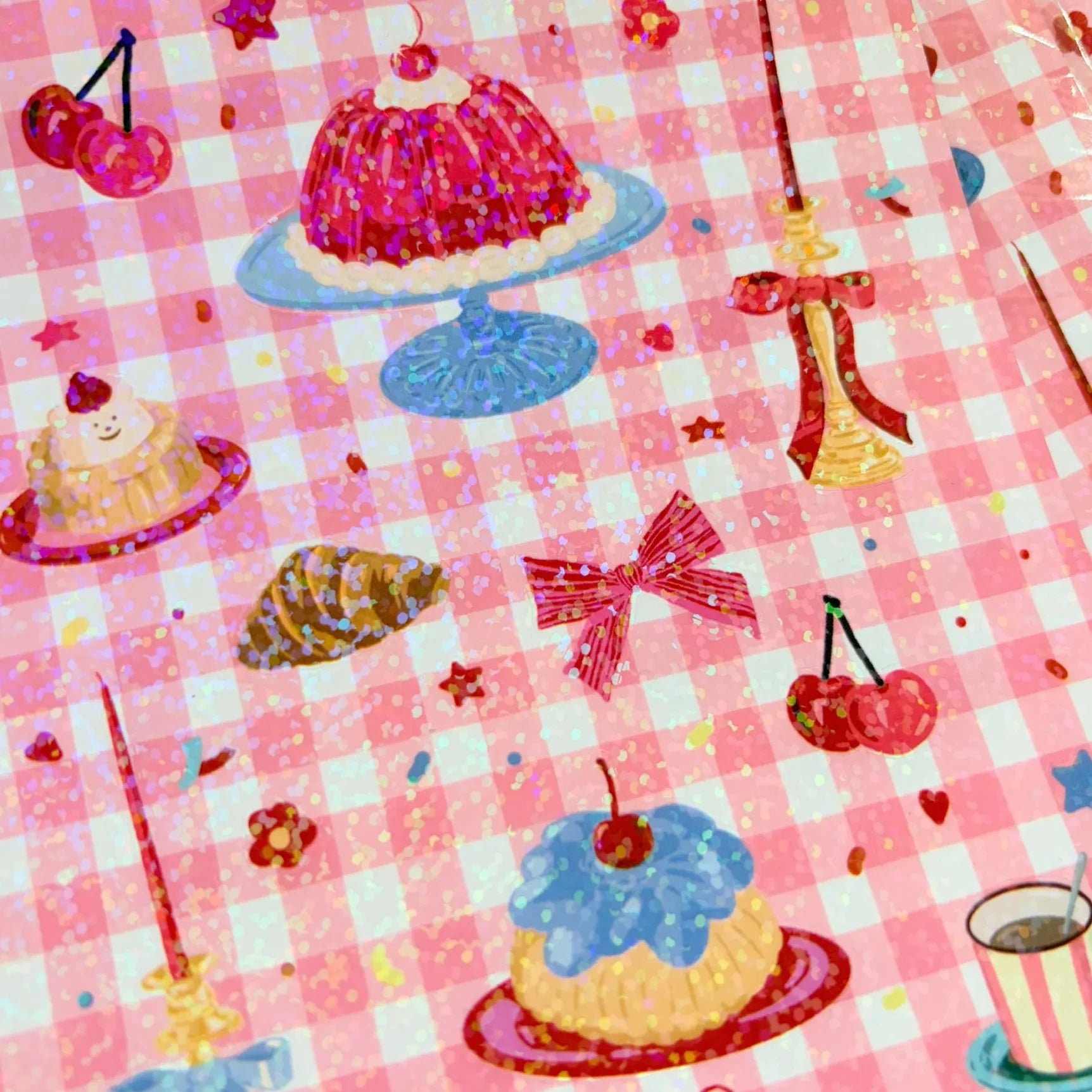 detalle del pack de pegatinas de Laura Ortiz con purpurina y dibujos de tartas y cosas de picnic, cerezas, un lazo y una taza de café