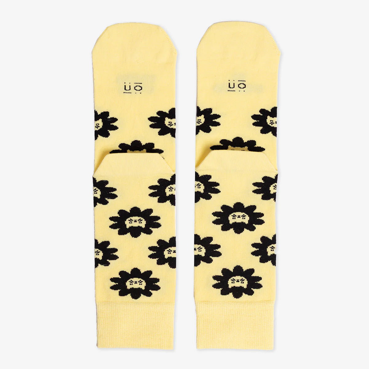 Parte de atrás de los calcetines amarillos con estampado de caras de gato y el mensaje "Mi gato manda / yo obedezco"