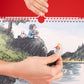 Detalle del Calendario de pared 2027 de Macanudo con una mano pegando una pegatina sobre una de las ilustraciones