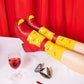 modelo llevando los calcetines paella con unos zapatos de tacón rojos apoyando las piernas sobre una mesa con una copa de vino y una cortina roja de fondo