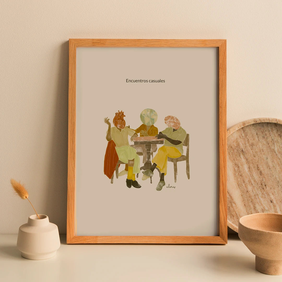 Print enmarcada de la artista Alera Vida con ilustración de tres personas con cabeza de corazón, cerebro y bola del mundo, charlando sentadas a la mesa y el texto "encuentros casuales"