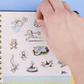 Hoja de pegatinas de agenda 2027 Macanudo con ilustraciones de personajes de Liniers: Olga, Enriqueta, Fellini y otros