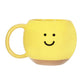 Taza amarilla con carita sonriente. 