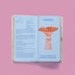 Ilustración de la agenda pocket Astro 2027 de Happimess con portada negra, con páginas azules y la ilustración de una seta roja.