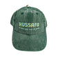gorra de frente en color verde bosque con el texto Russafa, el barri amb nom de jardí, en color azul y amarillo
