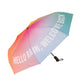 Paraguas plegable con esqueleto negro y estampado degradado de colores con el mensaje Hello rain, welcome back en letras mayúsculas blancas