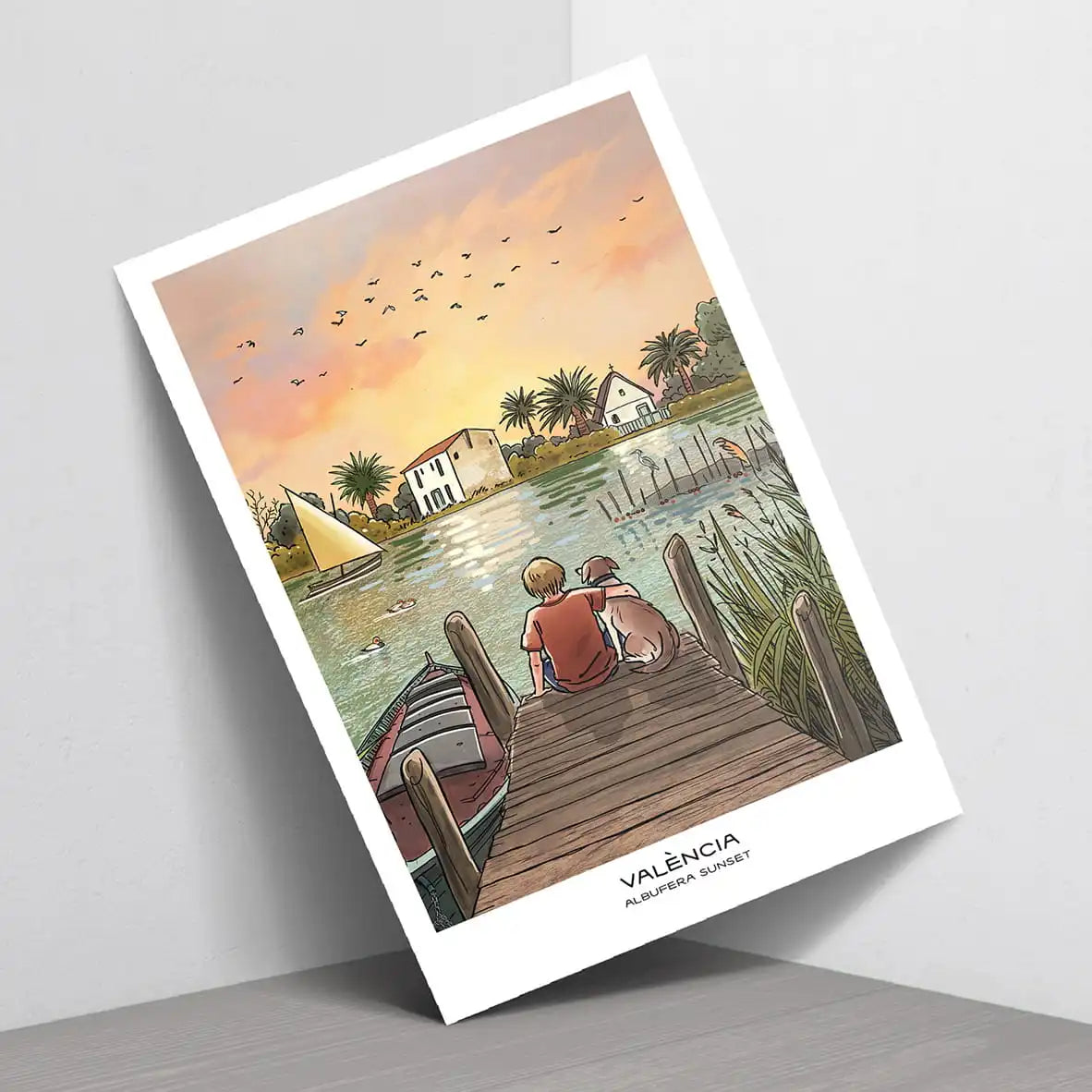 Postal de VLC Prints donde se ve el atardecer en la albufera de Valencia. En el dibujo sale una persona abrazando un perro y viendo el más allá del agua y del cielo. 