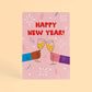 Tarjeta de Navidad plantable de Resetea, con ilustración de dos manos rindando con champán y el mensaje Happy New Year!