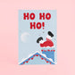 Tarjeta de Navidad plantable de Resetea, con ilustración de un papá noel entrando por una chimenea y el mensaje HO HO HO!