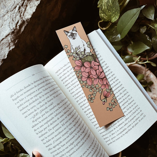 Libro abierto sobre la vegetación con el punto de libro ilustrado por Laura Agustí