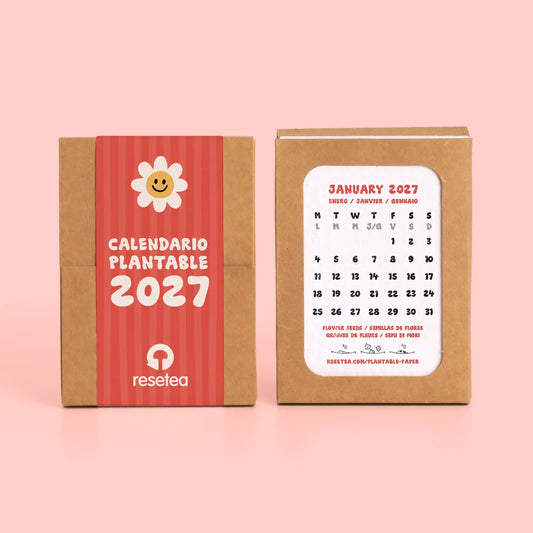calendario de resetea plantable del 2027  cerrado con una banda de papel en color rojo a rallas y con un dibujo de una flor y abierto con la primera hoja enseñando el mes de enero en color negro con acentos en rojo
