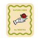 Pin de madera con forma de mano con guante blanco sosteniendo una flor roja con el mensaje Grow wild