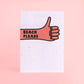 postal con semillas dentro de la marca resetea con un puño cerrado levantando el pulgar con el texto Beach please,