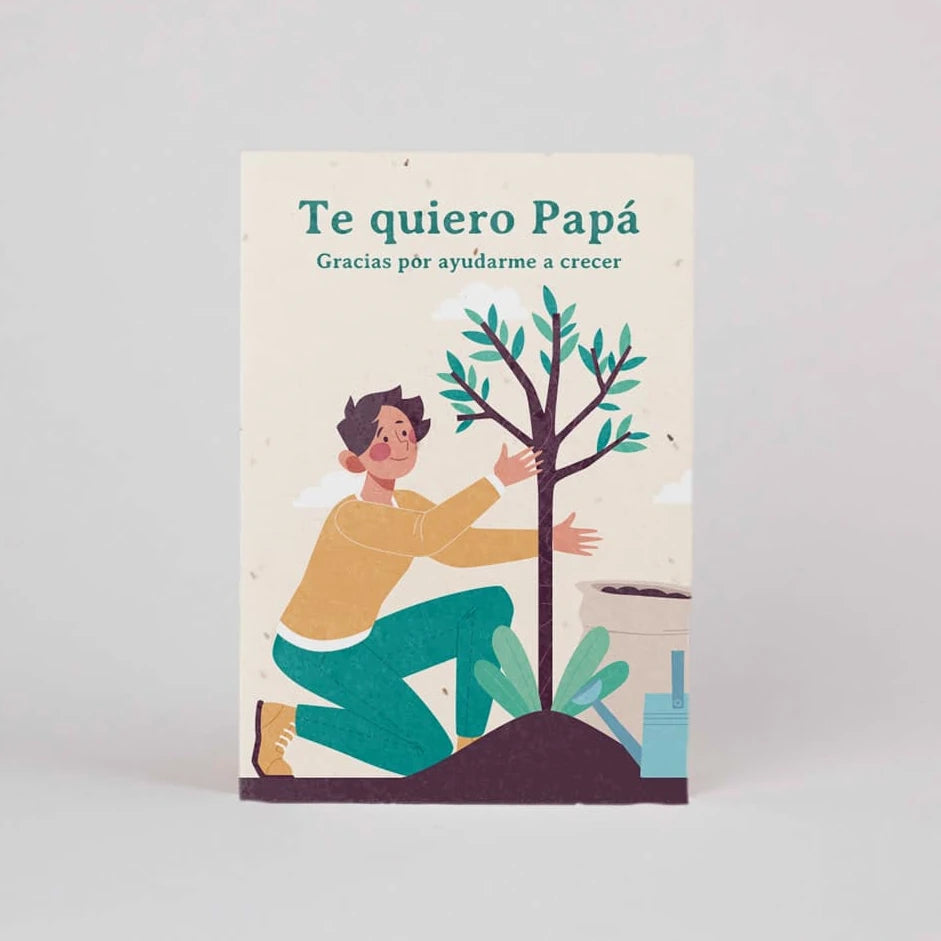 postal plantable con semillas dentro con un chico arrodillado frente a un árbol ayudándolo a crecer y con el texto "te quiero papá, Gracias por ayudarme a crecer"