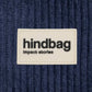 Tejido de pana azul marino con etiqueta de la marca hindbag