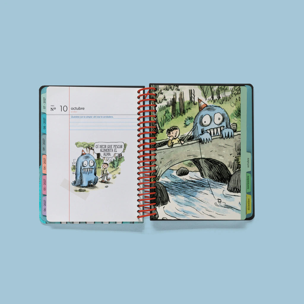 Páginas interiores de la agenda Macanudo de Liniers 2027 anillada y abierta por la portadilla de octubre con ilustración a página completa de un niño y el monstruo Olga pescando en el río