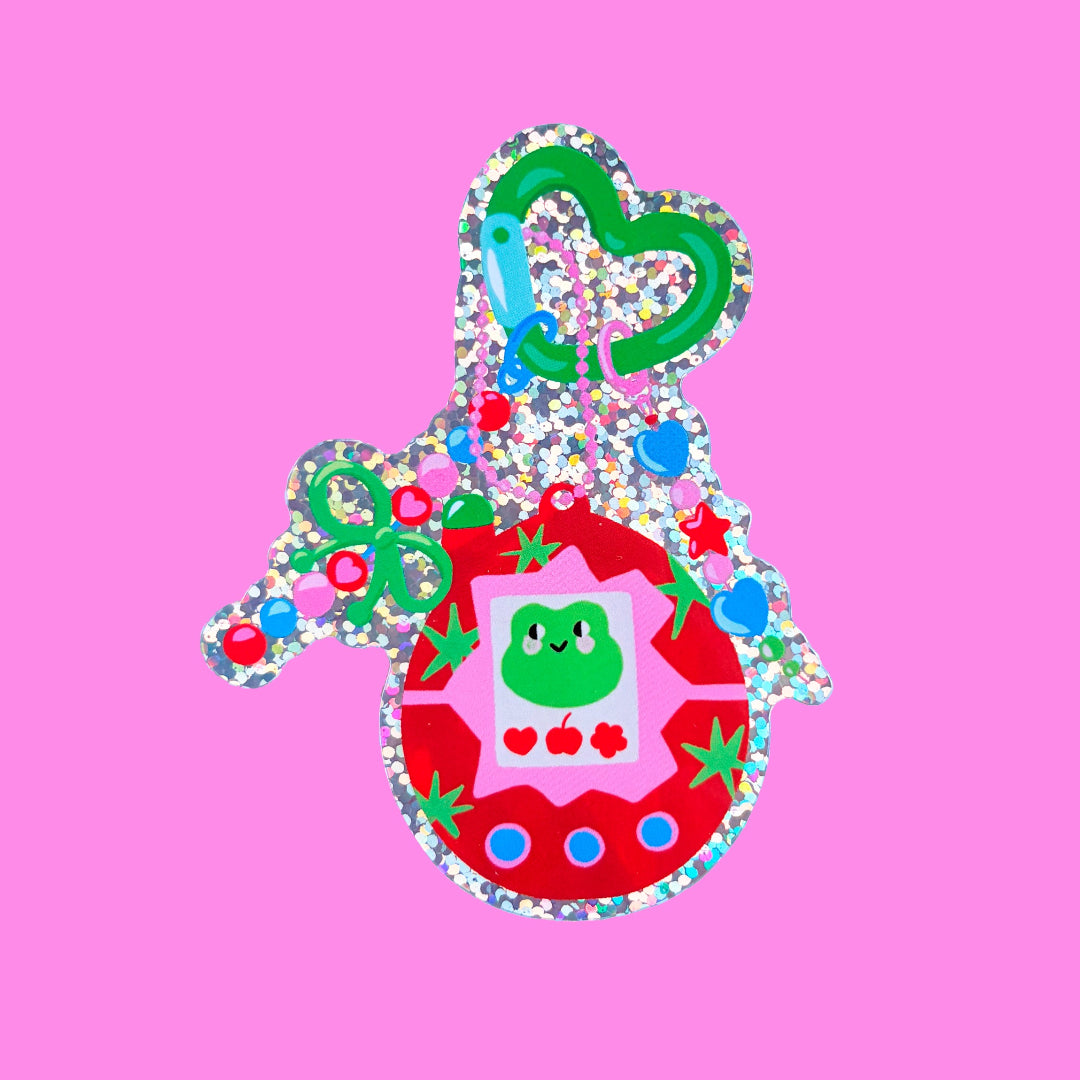 pegatina tamagochi con imagen de una rana con fondo rosa