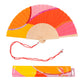  abanico de la marca fisura con ondas en colores amarillo, naranja y rosa, y con purpurina de colores, con la cuerda roja para colgarlo al cuello o a la mano, y su caja