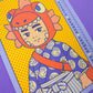 Lámina del calendario de Yeahhh Studio de un niño vestido con kimono con casco de cabeza de pez 
