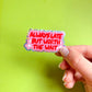 manosujetando pegatina con texto "always late but worth the wait" con texto rojo, fondo rosa y borde brillante