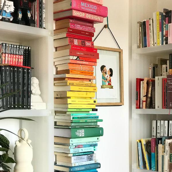 Libros ordenados por colores en una estantería vertical invisible 