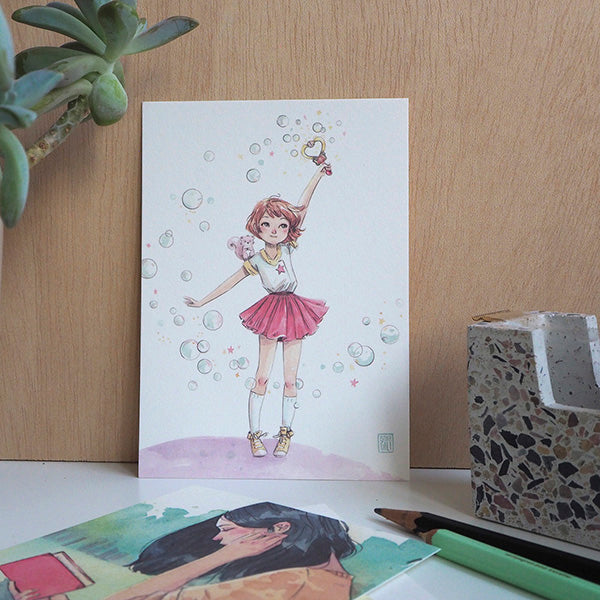 Ilustración de de una niña con burbujas en el pack rojo de postales de la ilustradora Esther Gili